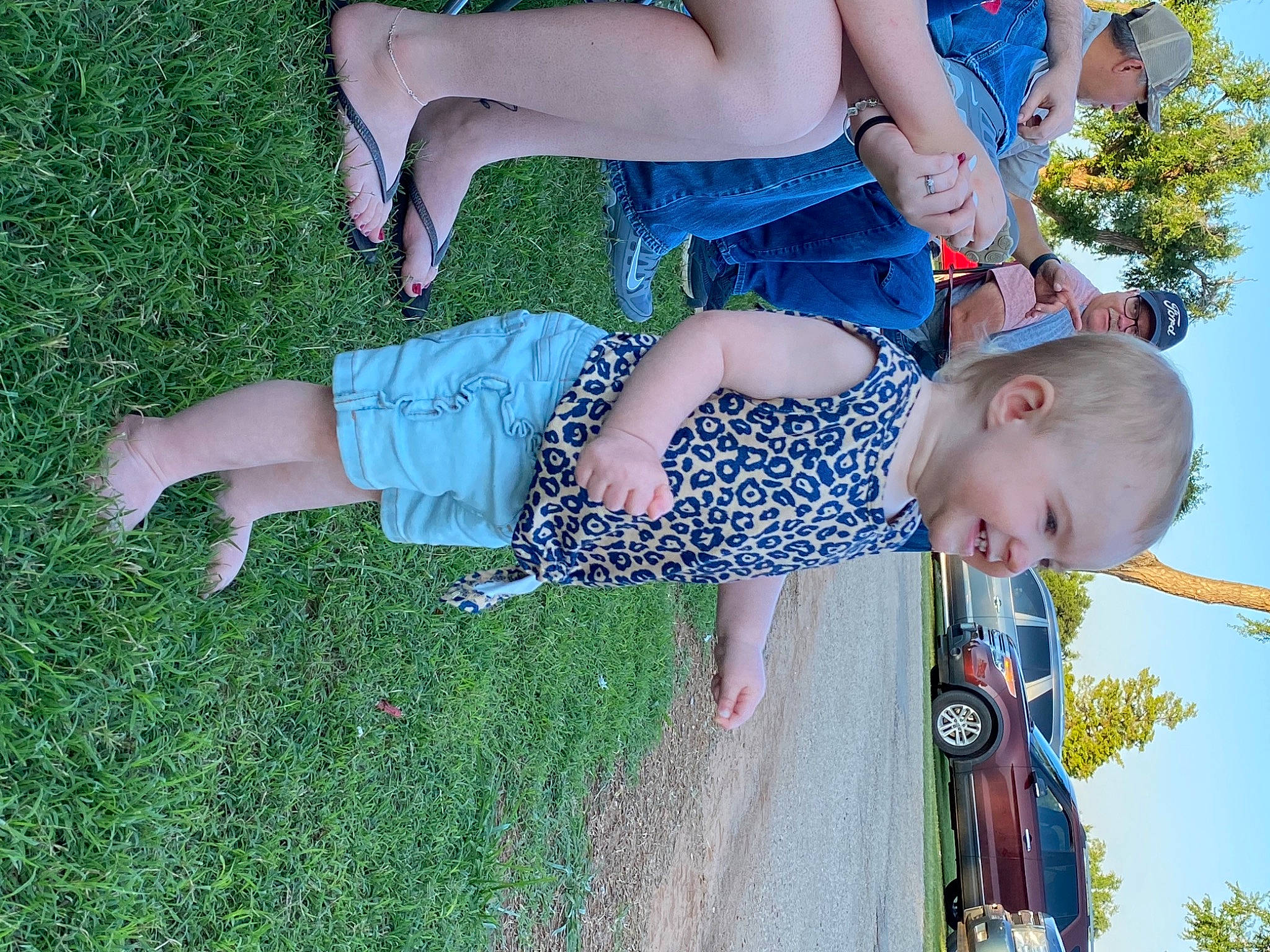 Addalyn is registered to the contest to win money with this photo: arm, clothing, dress, fun, grass, green, happy, head, headwear, joint, joy, leisure, people, people_in_nature, person, plant, shorts, sky, summer, sunglasses