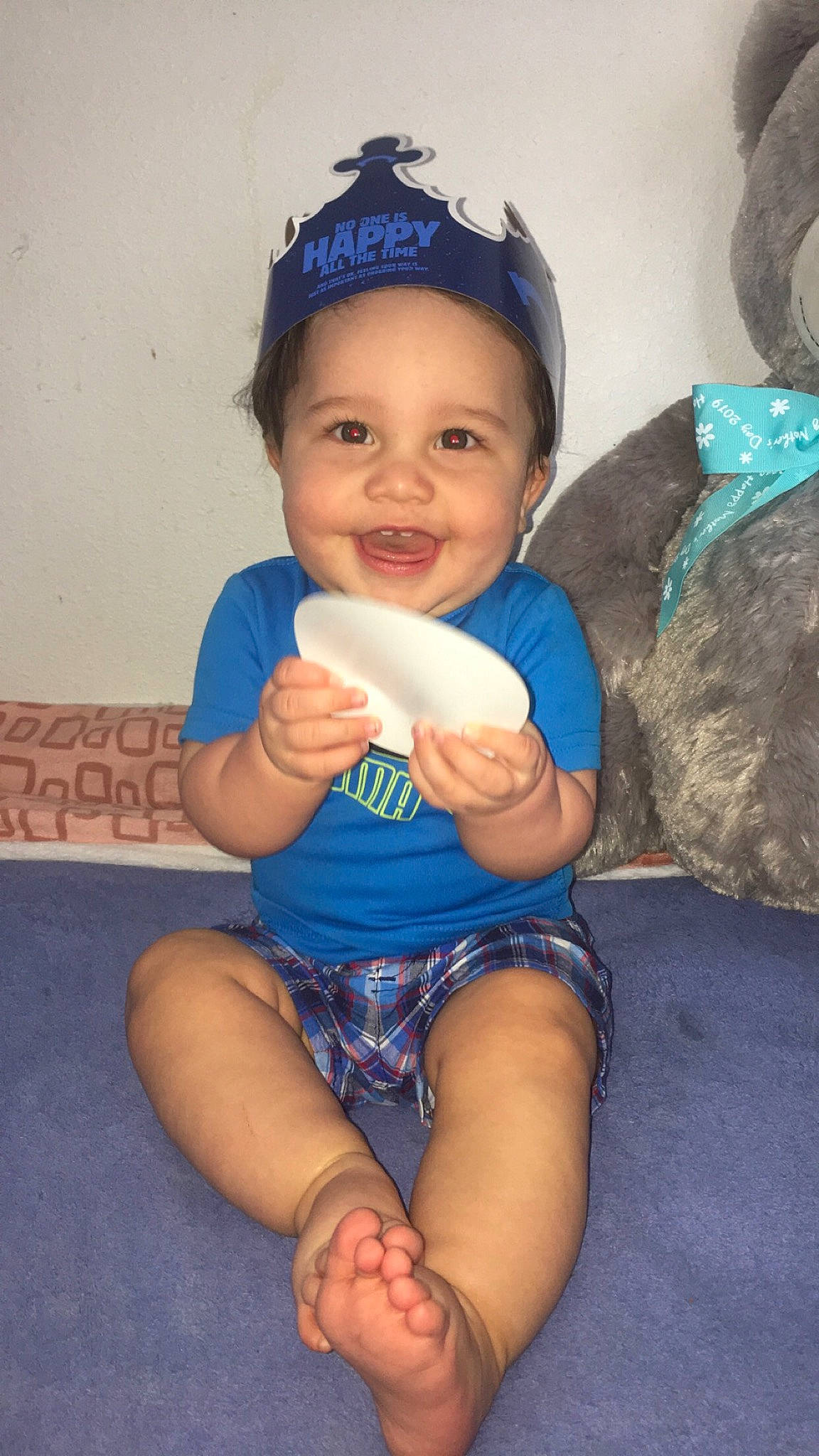 Demitri is registered to the contest to win money with this photo: arm, baby, baby_toddler_clothing, blue, cheek, child, finger, headgear, joy, leg, person, sitting, skin, smile, thumb, toddler