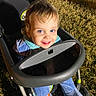 Nolan is registered to the contest to win money with this photo: baby, clothing, face, grass, happy, head, machine, nature, outdoors, pants, park, person, photography, plant, portrait, smile, stroller, transportation, vehicle, wheel
