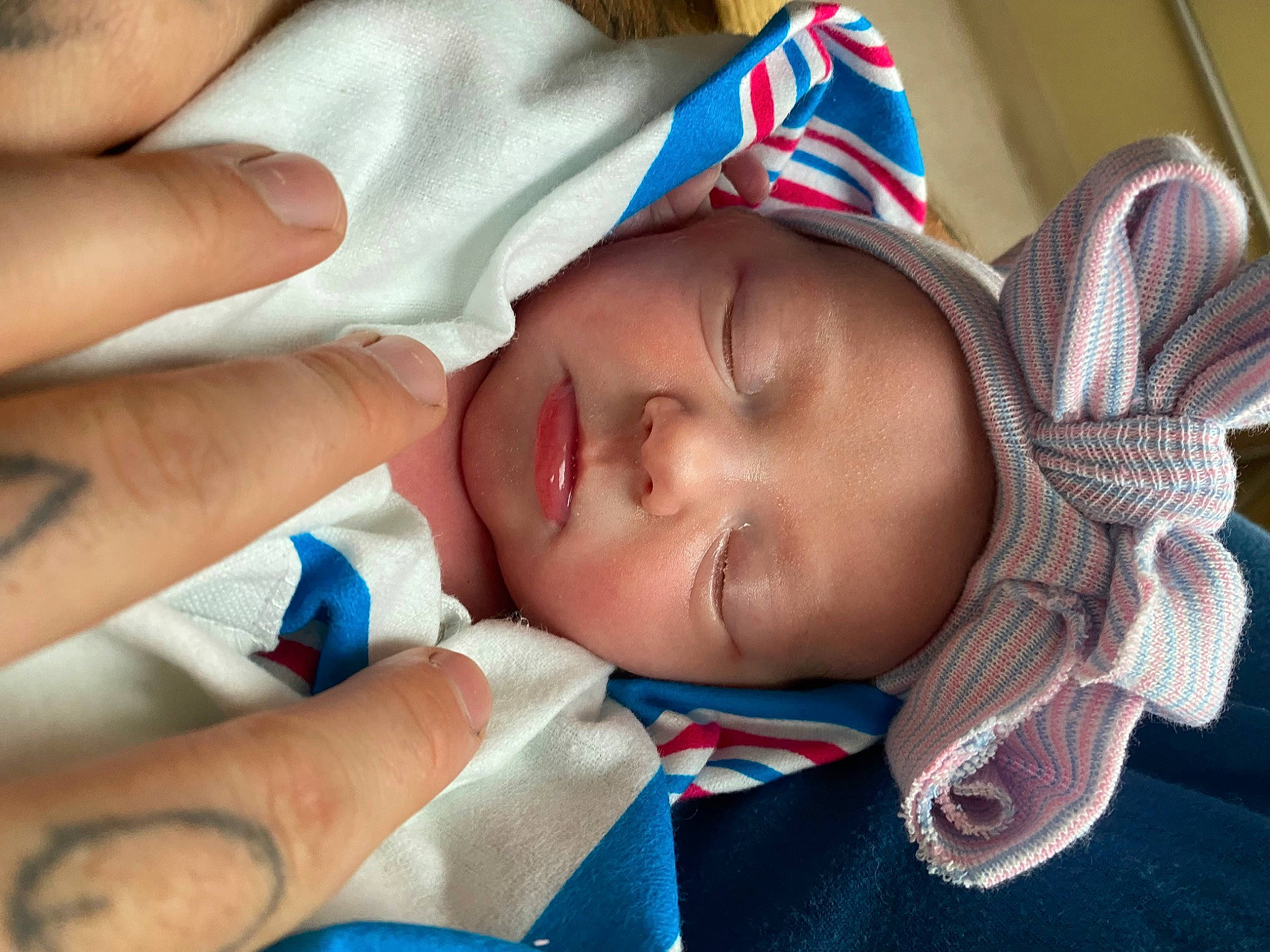 Lilianna is registered to the contest to win money with this photo: baby, cheek, child, comfort, electric_blue, eyelash, fashion_accessory, finger, gesture, happy, headgear, headwear, linens, lip, mouth, nail, nose, person, skin, textile