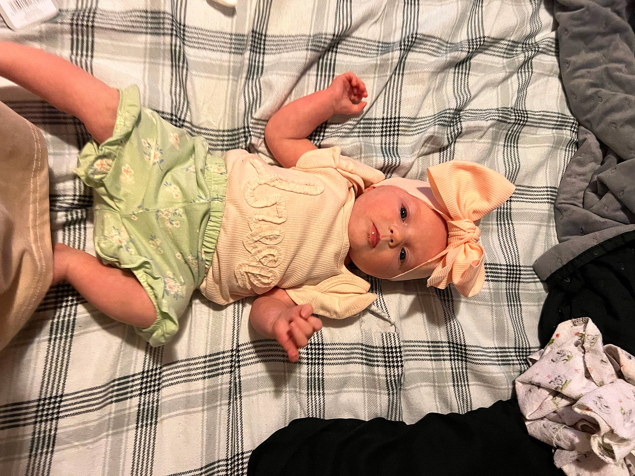 Lilianna is registered to the contest to win money with this photo: baby, baby_products, baby_safety, baby_sleeping, baby_toddler_clothing, child, comfort, gesture, hat, headwear, human_body, linens, nail, pattern, person, plaid, skin, sleeve, tartan, textile