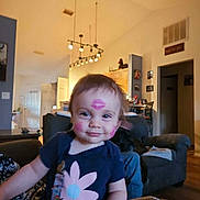 Amara joined the competition — help win amazing prizes! child, toddler, baby, face, kiss_mark, lipstick, smile, living_room, sofa, couch, shirt, flower_print, hand, lamp, ceiling, home_interior, furniture, playful, portrait, cute