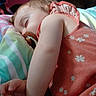 arm, baby, bed, blanket, child, cozy, dress, eyelashes, face, floral_pattern, hand, indoor, nap, pacifier, pillow, sleeping, soft_texture, stripes, toddler, toy