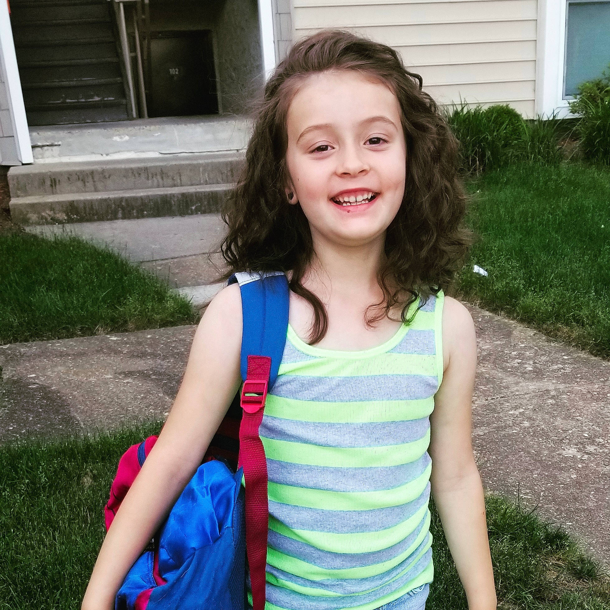 Esmae joined the competition — help win amazing prizes! brown_hair, child, child_model, face, fun, grass, hair, happy, joy, leisure, long_hair, person, plant, play, shoulder, sleeve, smile, summer, t_shirt, toddler