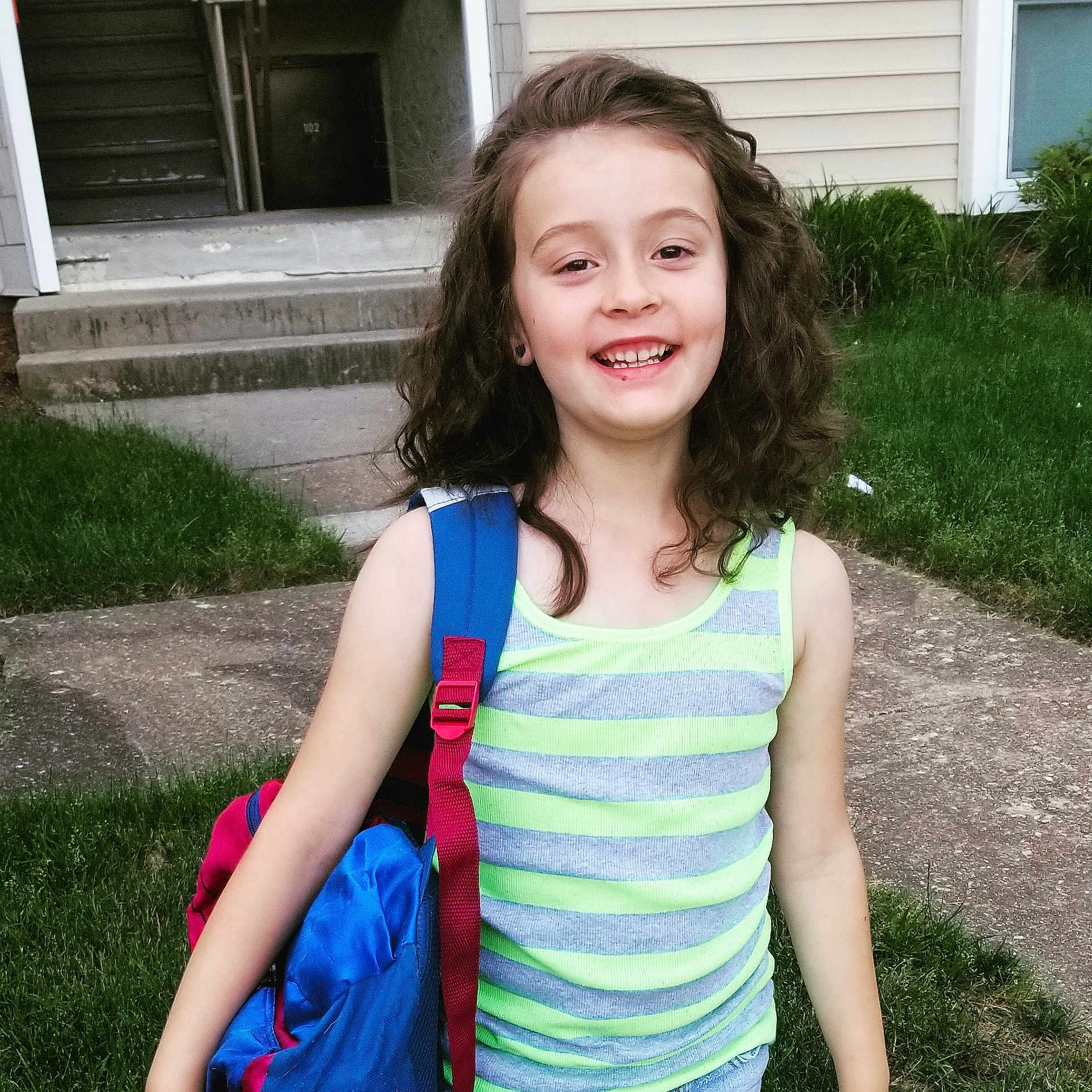Esmae joined the competition — help win amazing prizes! brown_hair, child, child_model, face, fun, grass, hair, happy, joy, leisure, long_hair, person, plant, play, shoulder, sleeve, smile, summer, t_shirt, toddler