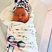 Aubriella joined the competition — help win amazing prizes! newborn, baby, infant, sleeping, portrait, face, indoors, blanket, swaddled, bow, headband, floral, cozy, nursery, crib, bedding, peaceful, cute, photography, child