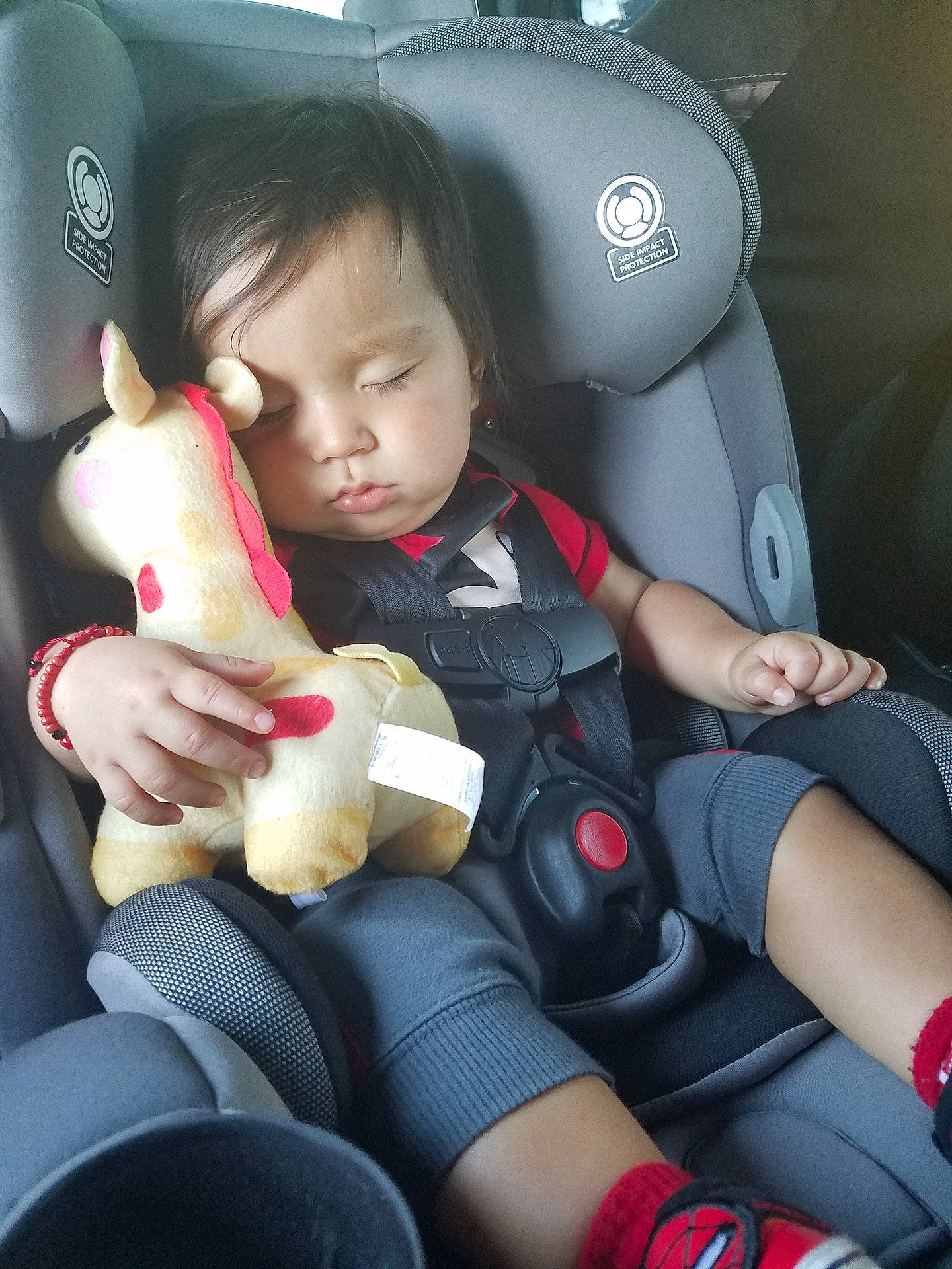 Xavier is registered to the contest to win money with this photo: car_seat, child, finger, girl, hand, person, product, toddler