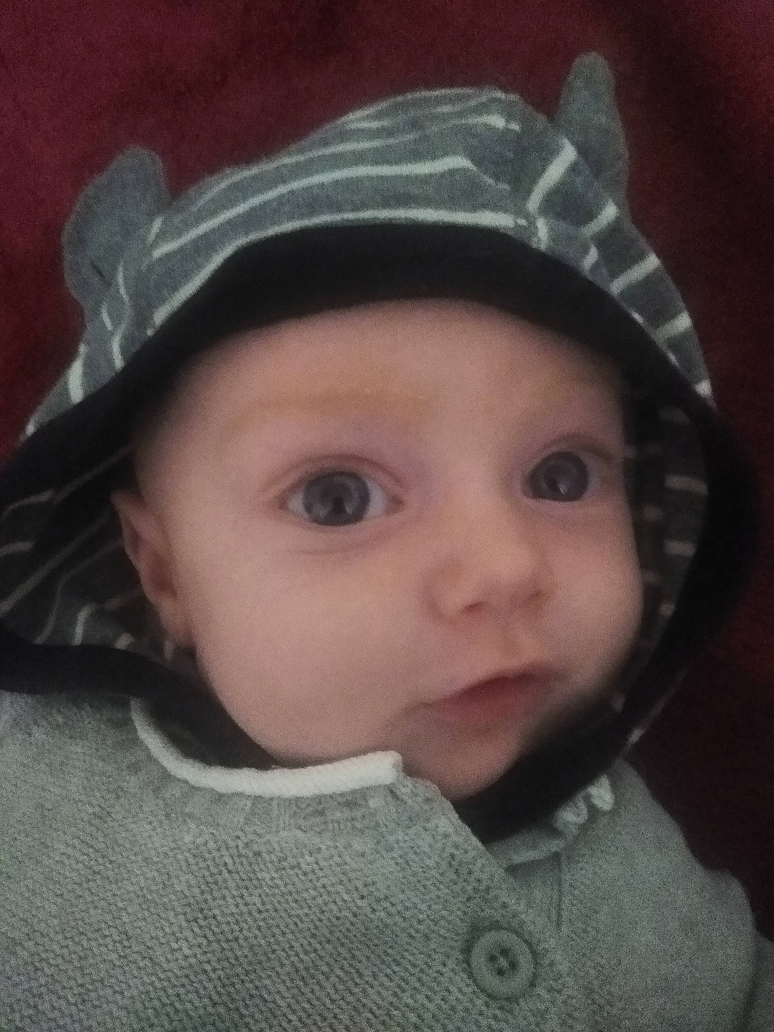 Liam is registered to the contest to win money with this photo: baby, cap, cheek, child, chin, costume_hat, eye, eyebrow, eyelash, fashion_accessory, flash_photography, hat, headgear, headwear, helmet, iris, knit_cap, lip, person, sun_hat