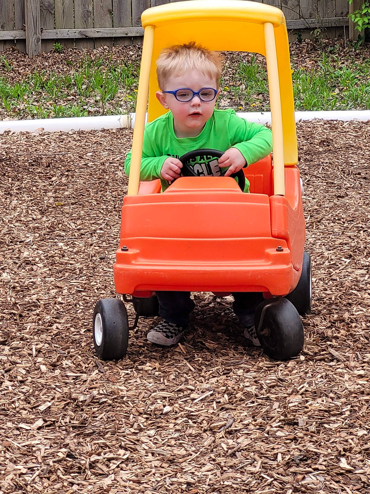 Kason is registered to the contest to win money with this photo: automotive_wheel_system, baby, baby_toddler_clothing, child, city, fun, grass, leisure, people_in_nature, person, plant, play, riding_toy, rolling, sitting, soil, tire, toddler, vehicle, wheel