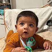 Viyan Thèo participe au concours pour gagner de l'argent avec cette photo : baby, infant, child, pacifier, toy, blanket, carpet, onesie, hands, face, eyes, hair, gaze, portrait, indoor, home, cozy, curiosity, lying_down, expression