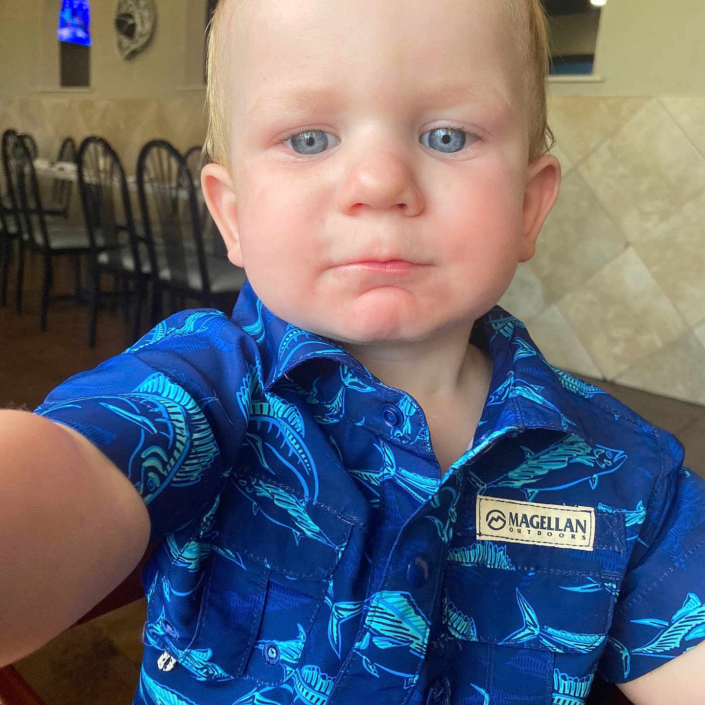 Weston joined the competition — help win amazing prizes! accessories, baby, chair, clothing, coat, face, frown, furniture, head, indoors, interiordesign, jacket, person, photography, portrait, sad, shirt, sleeve, t_shirt, table
