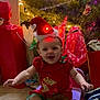 Abigail is registered to the contest to win money with this photo: baby, celebration, chair, child, christmas_lights, christmas_tree, decorations, festive, floor, happy, hat, holiday, indoor, infant, joyful, presents, red_clothing, seasonal, smile, tile_floor