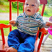 Colt joined the competition — help win amazing prizes! baby, child, blue_eyes, striped_shirt, jeans, red_chair, wooden_chair, outdoor, greenery, grass, wooden_floor, curious_expression, barefoot, casual_clothing, portrait, sitting, infant, cute, drool, daylight