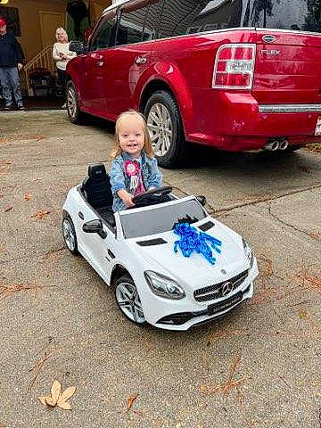 Kinsley joined the competition — help win amazing prizes! alloy_wheel, automotive_design, automotive_exterior, automotive_lighting, automotive_tire, blurred, bumper, car, fender, hood, jeans, joy, land_vehicle, motor_vehicle, person, personal_luxury_car, rim, smile, tire, vehicle