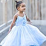 child, girl, blue_dress, twirling, happy, outdoor, sandals, headband, jewelry, portrait, smiling, young_child, fashion, cute, full_length, playful, daylight, accessories, expression, standing
