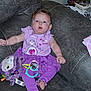 Feyre is registered to the contest to win money with this photo: baby, child, purple_clothing, plush_toy, couch, indoor, surprised_expression, barefoot, sitting, person, face, head, toy, furniture, casual, infant, legs, arms, home, comfort
