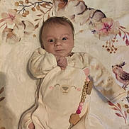 Loucya participe au concours pour gagner de l'argent avec cette photo : baby, infant, blanket, floral_pattern, onesie, pacifier, beads, hand, cute, soft_toys, child, lying_down, indoor, sleepwear, expression, face, person, comfort, peaceful, newborn