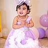toddler, child, dress, lavender, hat, smile, jewelry, bracelet, balloons, party, celebration, indoor, portrait, cute, happy, person, baby, fashion, accessories, floor