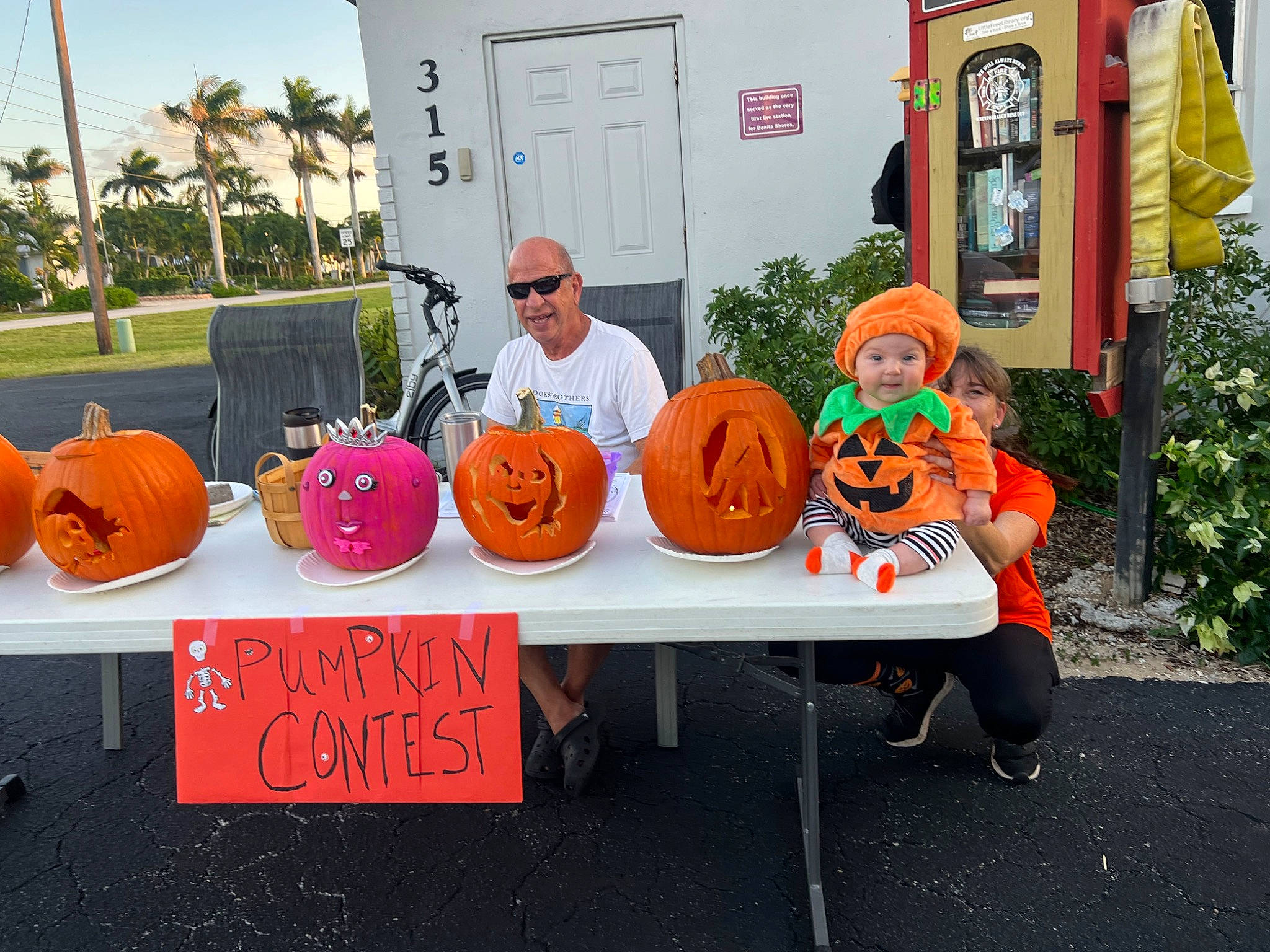 Paisley is registered to the contest to win money with this photo: building, calabaza, cucurbita, event, gourd, handwriting, hat, headwear, jack_o_lantern, joy, leisure, local_food, natural_foods, orange, palm_tree, person, plant, pumpkin, squash, sunglasses
