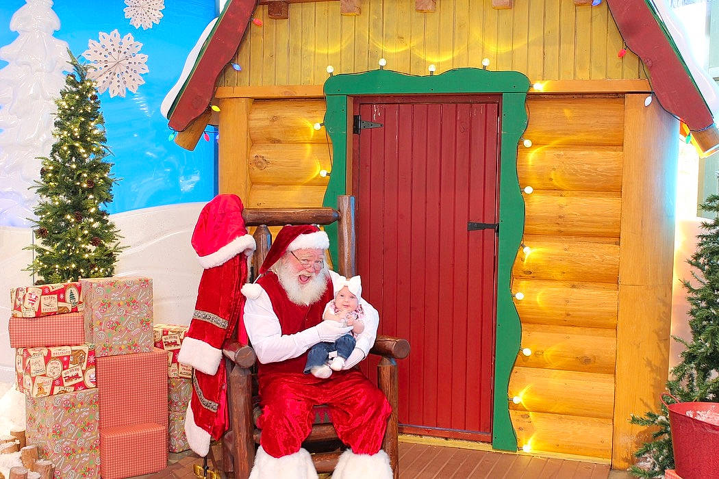 Paisley is registered to the contest to win money with this photo: building, christmas, christmas_decoration, christmas_tree, cottage, event, flowerpot, fun, hat, headwear, holiday, home, interior_design, leisure, log_cabin, person, property, red, santa_claus, tree