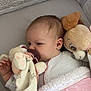 baby, infant, pacifier, plush_toy, blanket, crib, sleeping, soft_toy, cute, child, indoors, comfort, resting, cozy, pink, white_clothing, newborn, face, hand, fabric
