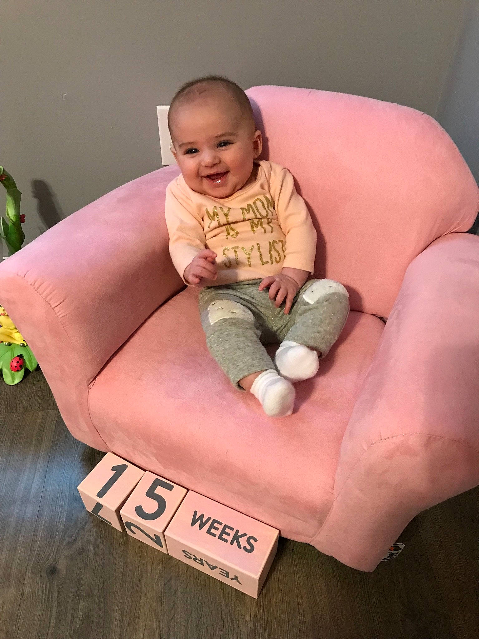 Austyn is registered to the contest to win money with this photo: baby, child, comfort, finger, furniture, hand, joy, leg, person, pink, play, sitting, skin, toddler