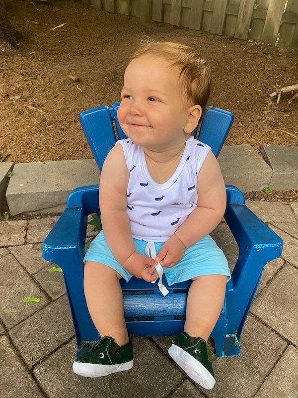 Jake is registered to the contest to win money with this photo: baby_products, baby_toddler_clothing, child, electric_blue, foot, fun, grass, happy, human_leg, joy, knee, leg, leisure, outdoor_furniture, person, play, recreation, sitting, smile, thigh