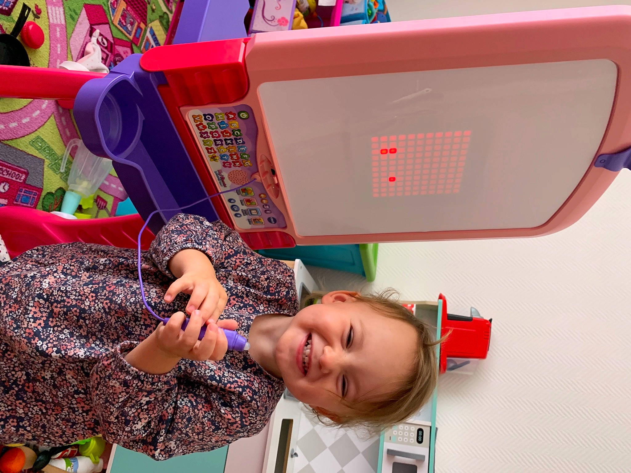 Chelsy participe au concours pour gagner de l'argent avec cette photo : art, child, event, eyewear, fun, happy, joy, leisure, magenta, pattern, person, pink, play, reading, room, shelf, smile, toddler, toy, travel