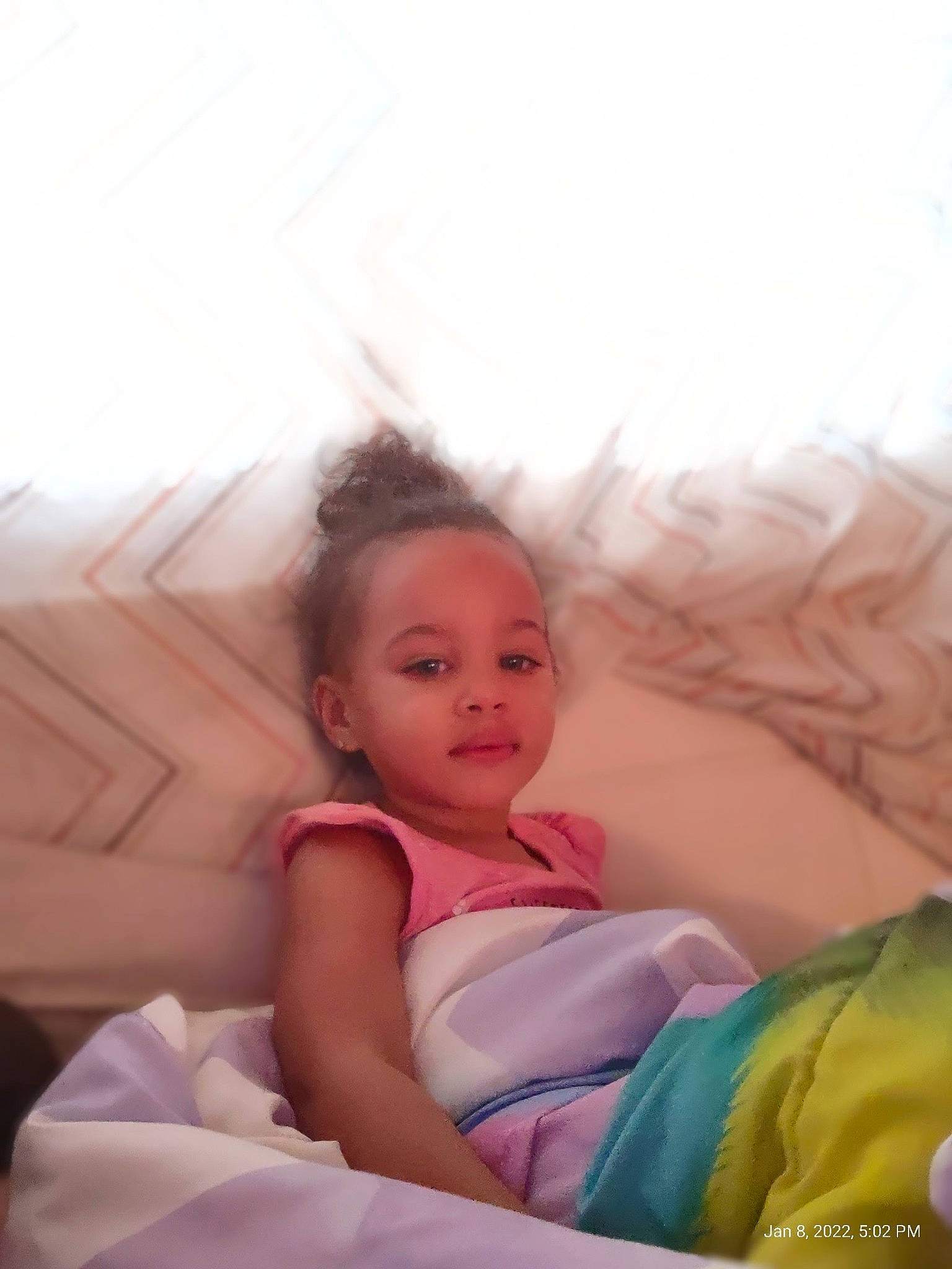 Aniyah is registered to the contest to win money with this photo: bed, blond, comfort, dress, event, eye, face, flash_photography, fun, happy, iris, leisure, linens, mammal, mouth, person, pink, skin, smile, textile