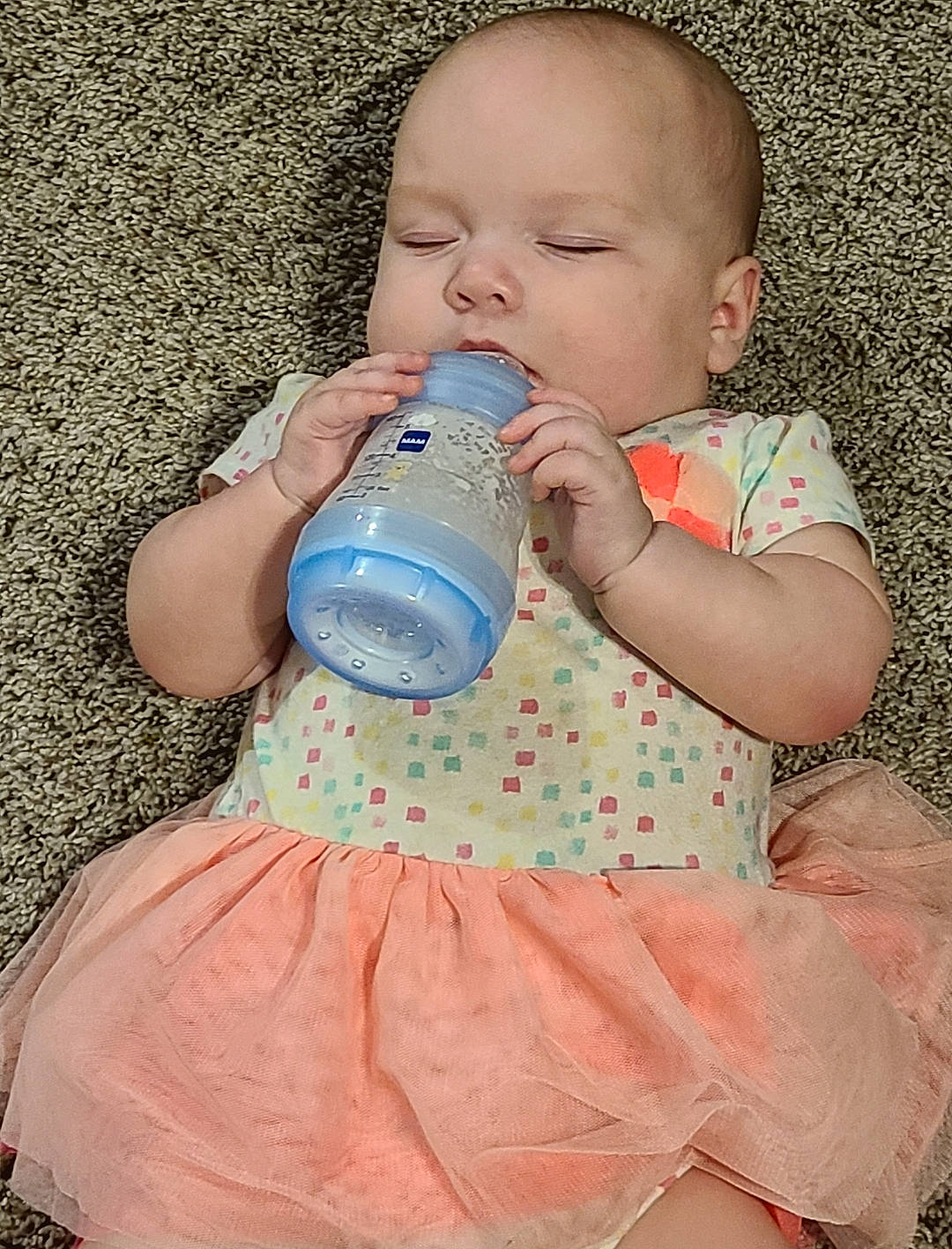 Opal is registered to the contest to win money with this photo: arm, baby, baby_bottle, baby_toddler_clothing, bottle, child, drinkware, face, finger, gesture, hand, happy, human_body, nail, people_in_nature, person, pink, plastic_bottle, skin, toddler
