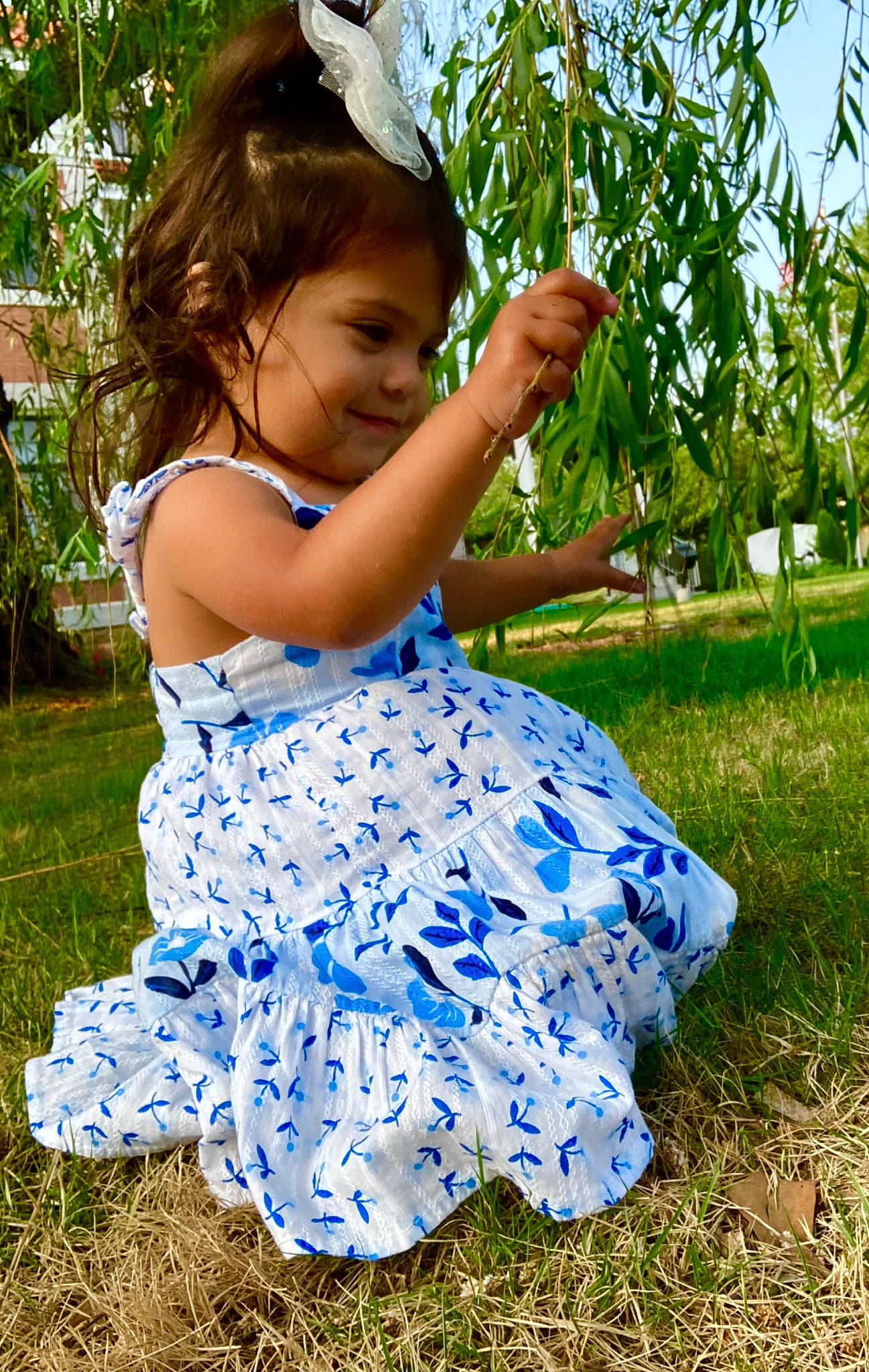 Annalise is registered to the contest to win money with this photo: baby_toddler_clothing, botany, child, dress, electric_blue, face, fun, grass, grassland, green, happy, joy, leisure, meadow, people_in_nature, person, plant, sky, smile, summer