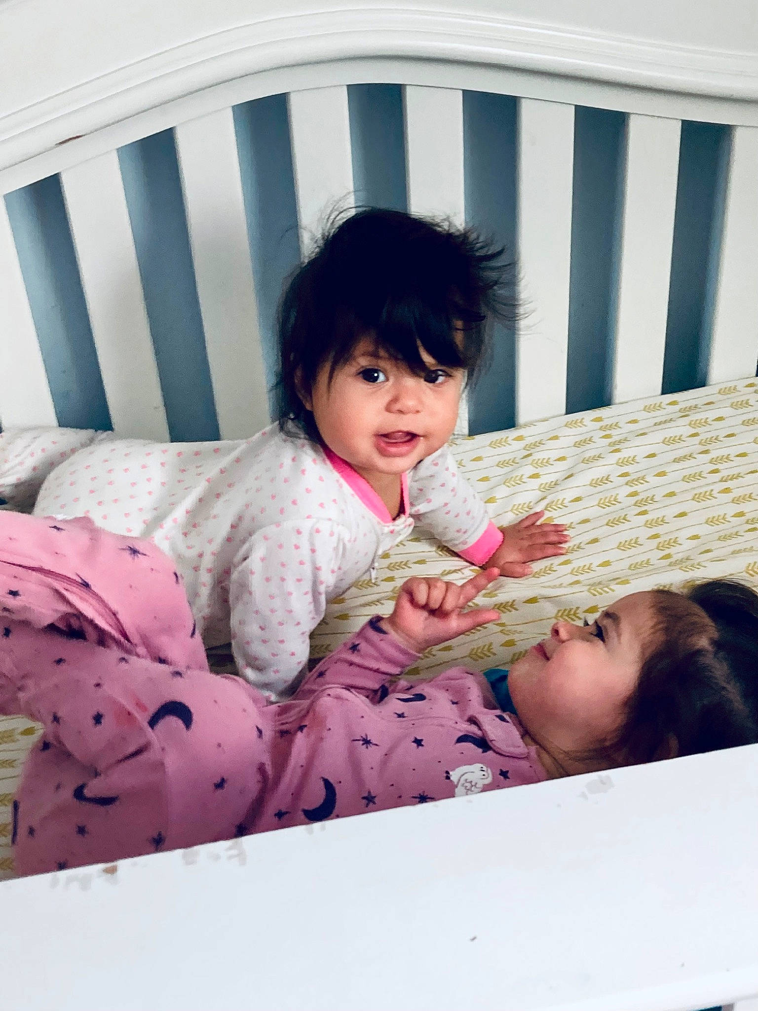 Annalise is registered to the contest to win money with this photo: baby, baby_toddler_clothing, bangs, bedding, child, comfort, couch, dress, fur, happy, leisure, linens, magenta, pattern, person, pink, room, sitting, skin, sleeve
