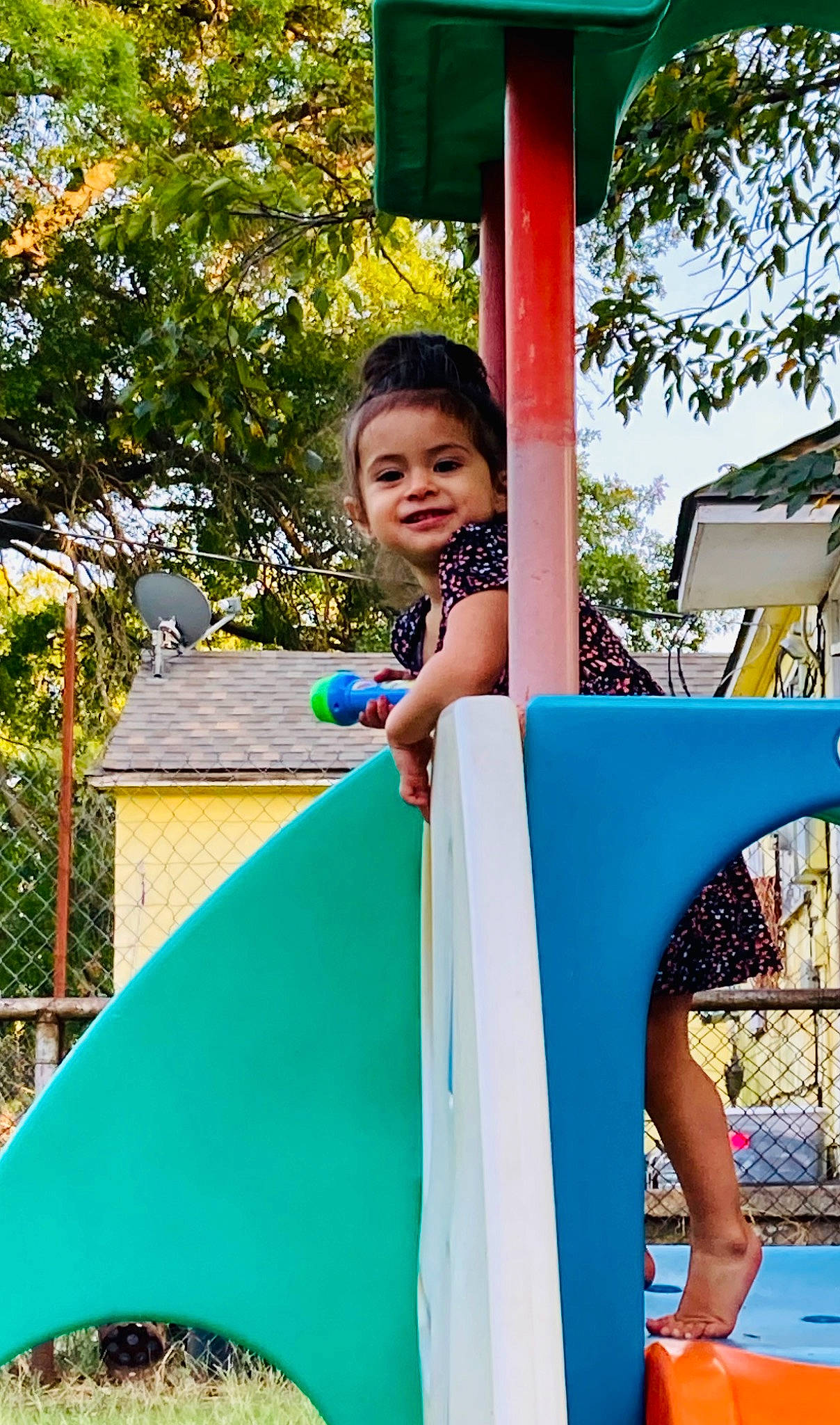 Evelyn is registered to the contest to win money with this photo: blue, child, chute, city, electric_blue, fun, grass, happy, joy, leisure, outdoor_play_equipment, person, play, playground, playground_slide, recreation, sitting, spring, t_shirt, toddler