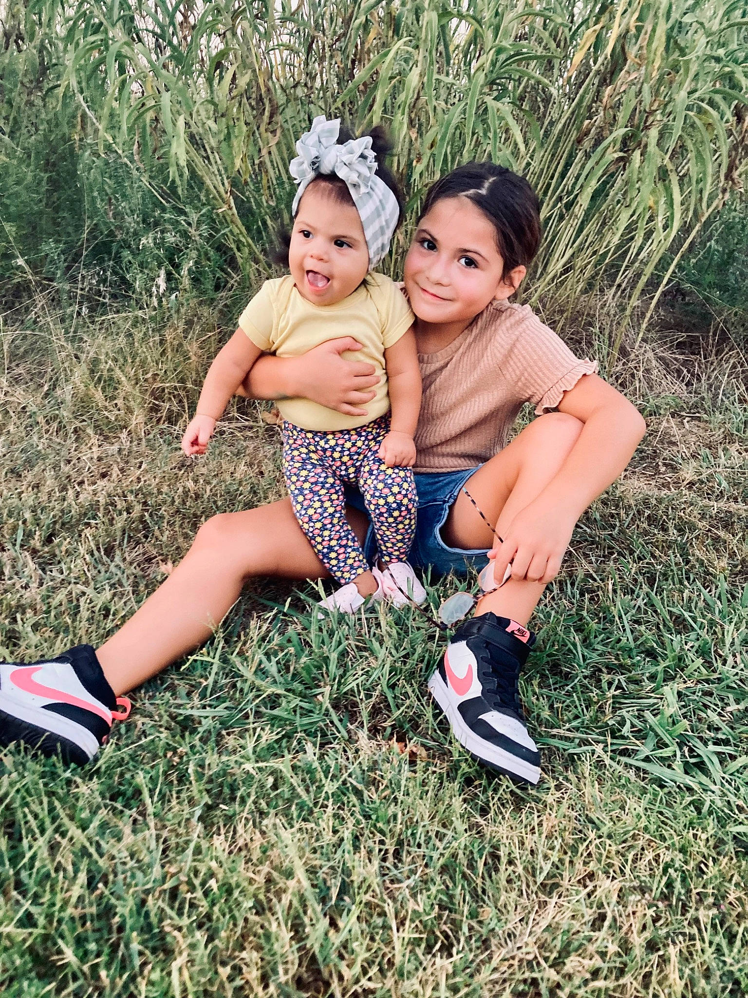 Arya joined the competition — help win amazing prizes! baby_toddler_clothing, botany, dress, eye, face, fun, grass, grass_family, happy, joy, leaf, leg, meadow, people_in_nature, person, plant, playing_with_kids, shoe, smile, sneakers