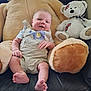 Ezekiel is registered to the contest to win money with this photo: baby, teddy_bear, plush_toy, child, couch, leather, smile, indoor, cute, comfort, soft_toy, seated, happy, infant, furniture, childrens_toy, relaxing, portrait, home, cozy