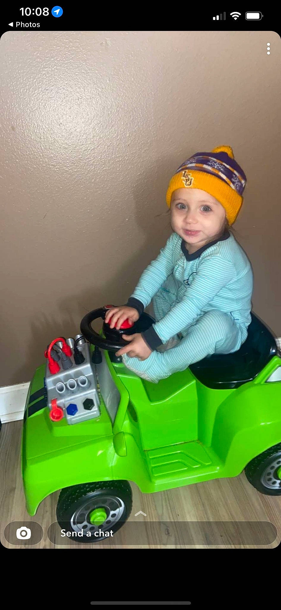 Weston is registered to the contest to win money with this photo: auto_part, automotive_design, automotive_tire, automotive_wheel_system, cap, eye, fun, grass, headwear, joy, mode_of_transport, motor_vehicle, person, plastic, product, riding_toy, smile, tire, toddler, toy