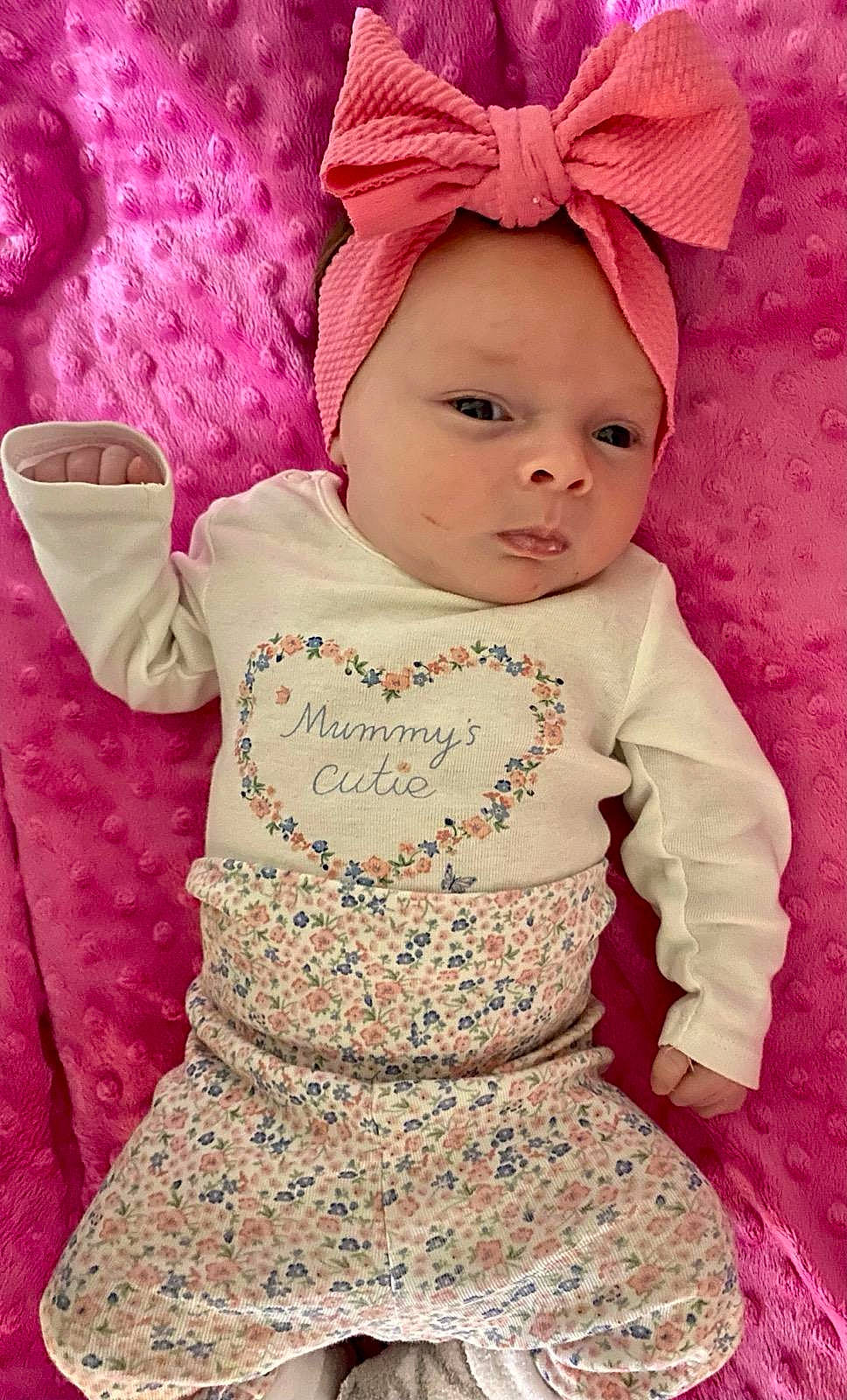 Willow is registered to the contest to win money with this photo: baby, baby_toddler_clothing, cap, cheek, costume_hat, day_dress, dress, embellishment, headwear, lip, magenta, one_piece_garment, outerwear, pattern, person, pink, purple, skin, sleeve, t_shirt