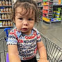 toddler, child, shopping_cart, supermarket, curly_hair, clothing, shirt, grocery_store, aisle, hand, person, indoor, expression, young_child, face, retail, shopping, cute, casual_wear, baby