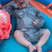 Walker joined the competition — help win amazing prizes! baby, sleeping, smiling, blue_cushion, orange_mesh, grey_outfit, infant, relaxed, hand_on_face, barefoot, cute, patterned_clothing, resting, child, portrait, indoors, soft_lighting, peaceful, small_person, comfort