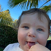 Troy joined the competition — help win amazing prizes! toddler, child, smiling, tongue_out, hand, blue_eyes, curly_hair, outdoor, daylight, greenery, palm_tree, sky, playful, cute, shirt, colorful_print, face, happy, nature, portrait