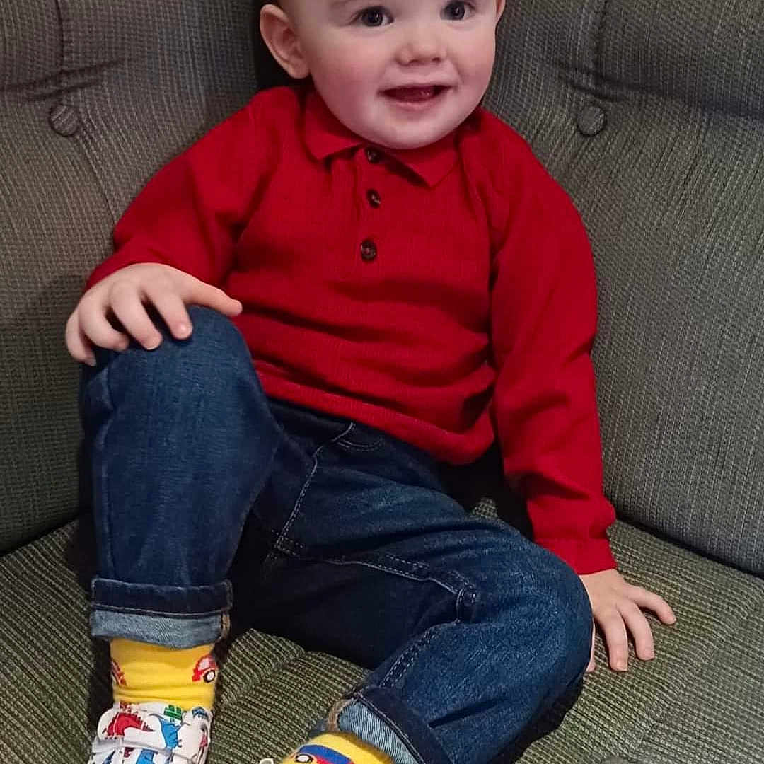 Mason is registered to the contest to win money with this photo: boy, child, clothing, couch, face, footwear, furniture, happy, head, hosiery, jeans, male, pants, person, photography, portrait, shoe, sitting, sneaker, sock