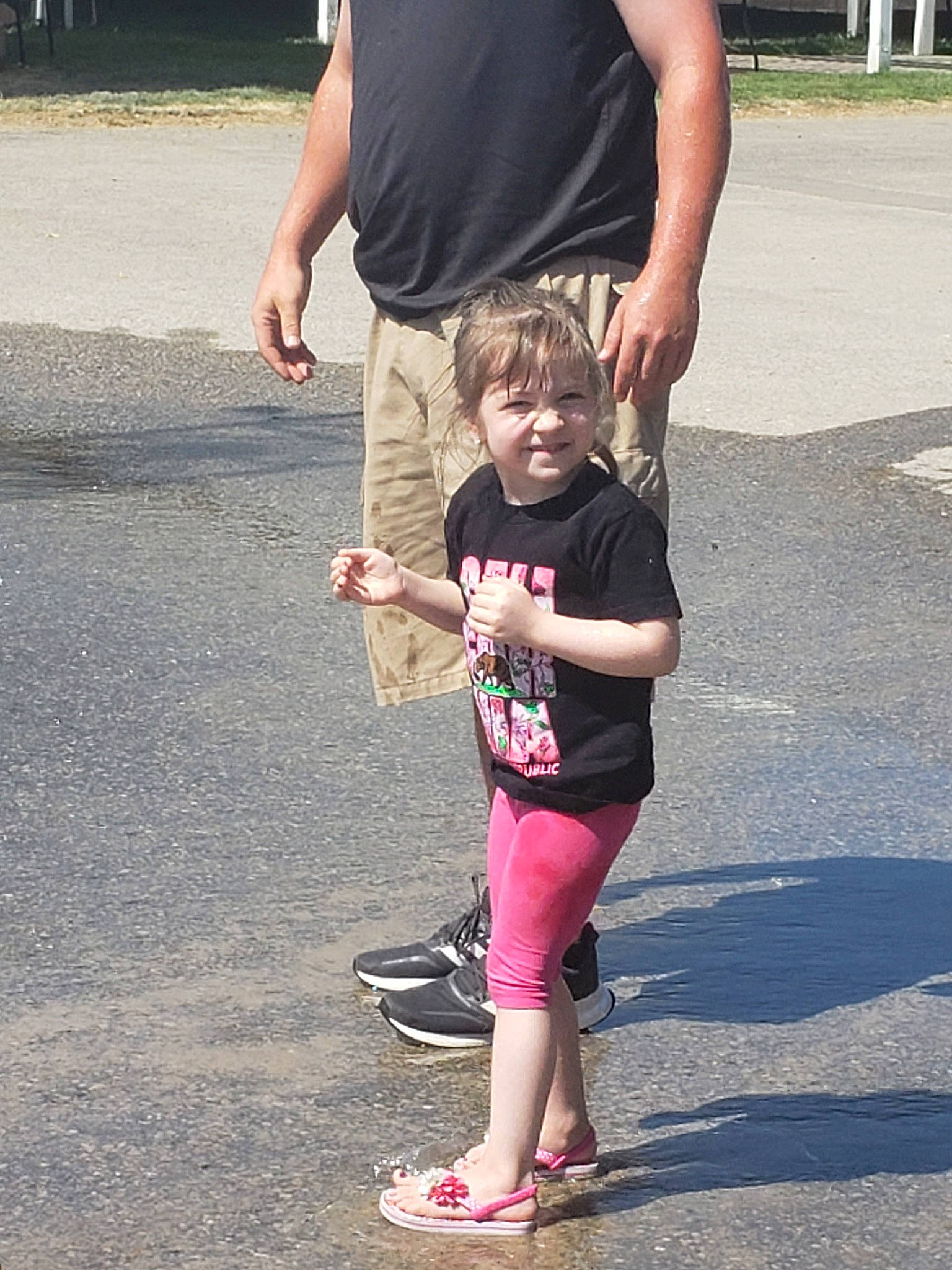 Taelynn is registered to the contest to win money with this photo: asphalt, child, daughter, footwear, fun, hand, joy, leg, people, person, pink, play, recreation, shoe, shorts, summer, t_shirt, toddler, vacation, walking