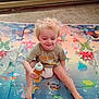 Colton joined the competition — help win amazing prizes! toddler, child, bottle, play_mat, underwater_theme, fish, turtle, octopus, smile, blonde_hair, sitting, barefoot, diaper, green_shirt, indoor, floor, carpet, happy, cute, playtime