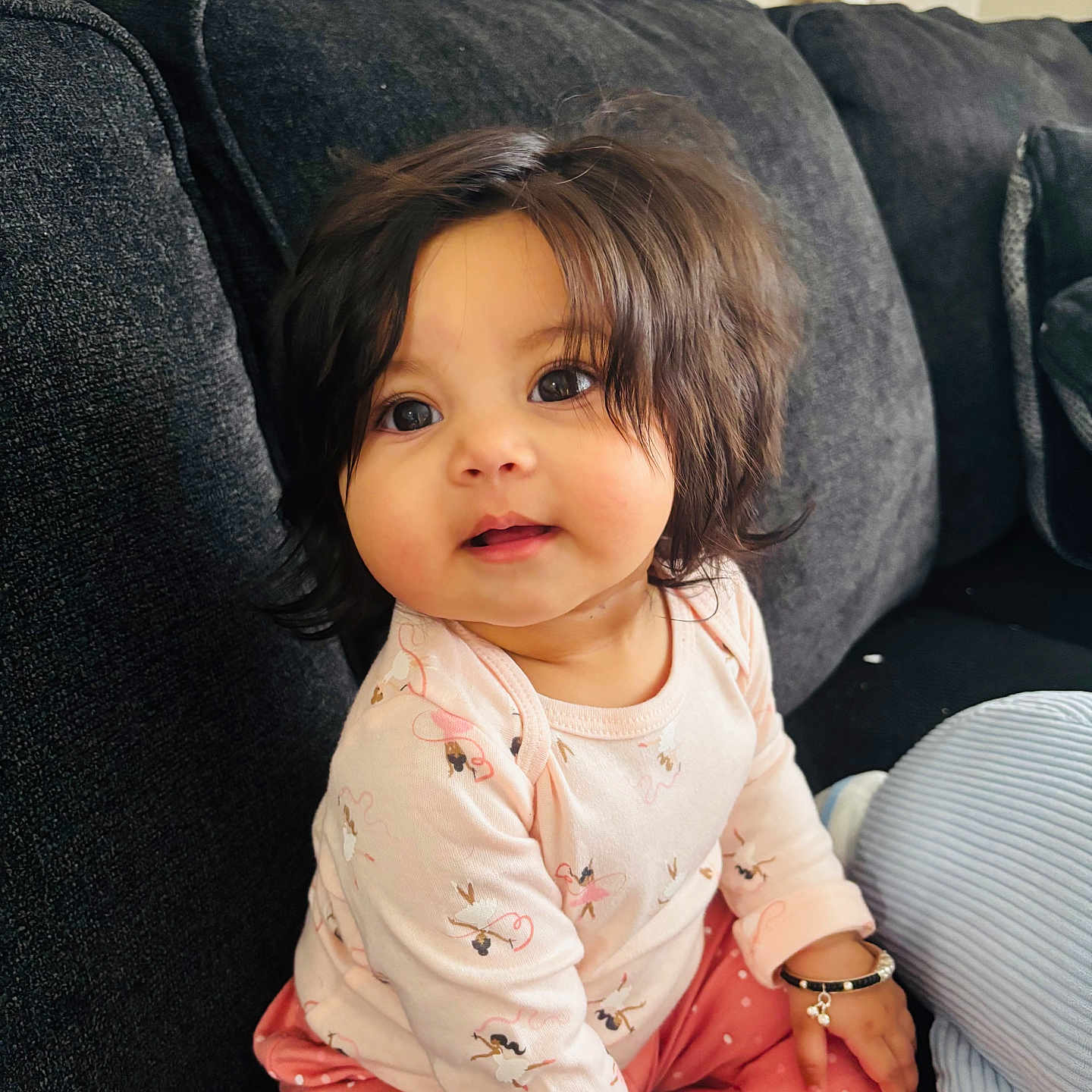 Imrat joined the competition — help win amazing prizes! baby, child, cute, pink_clothing, bracelet, sitting, couch, indoor, portrait, happy, face, person, young_child, long_hair, polka_dots, soft_lighting, home, cozy, infant, adorable