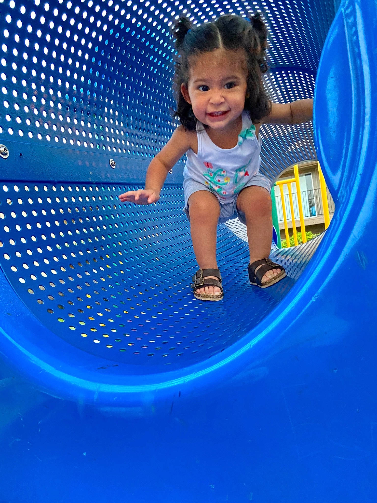 Alanna is registered to the contest to win money with this photo: automotive_exterior, automotive_tire, baby_toddler_clothing, blue, child, circle, electric_blue, facial_expression, flash_photography, fun, happy, hood, joy, leisure, outdoor_play_equipment, person, play, playground, purple, recreation