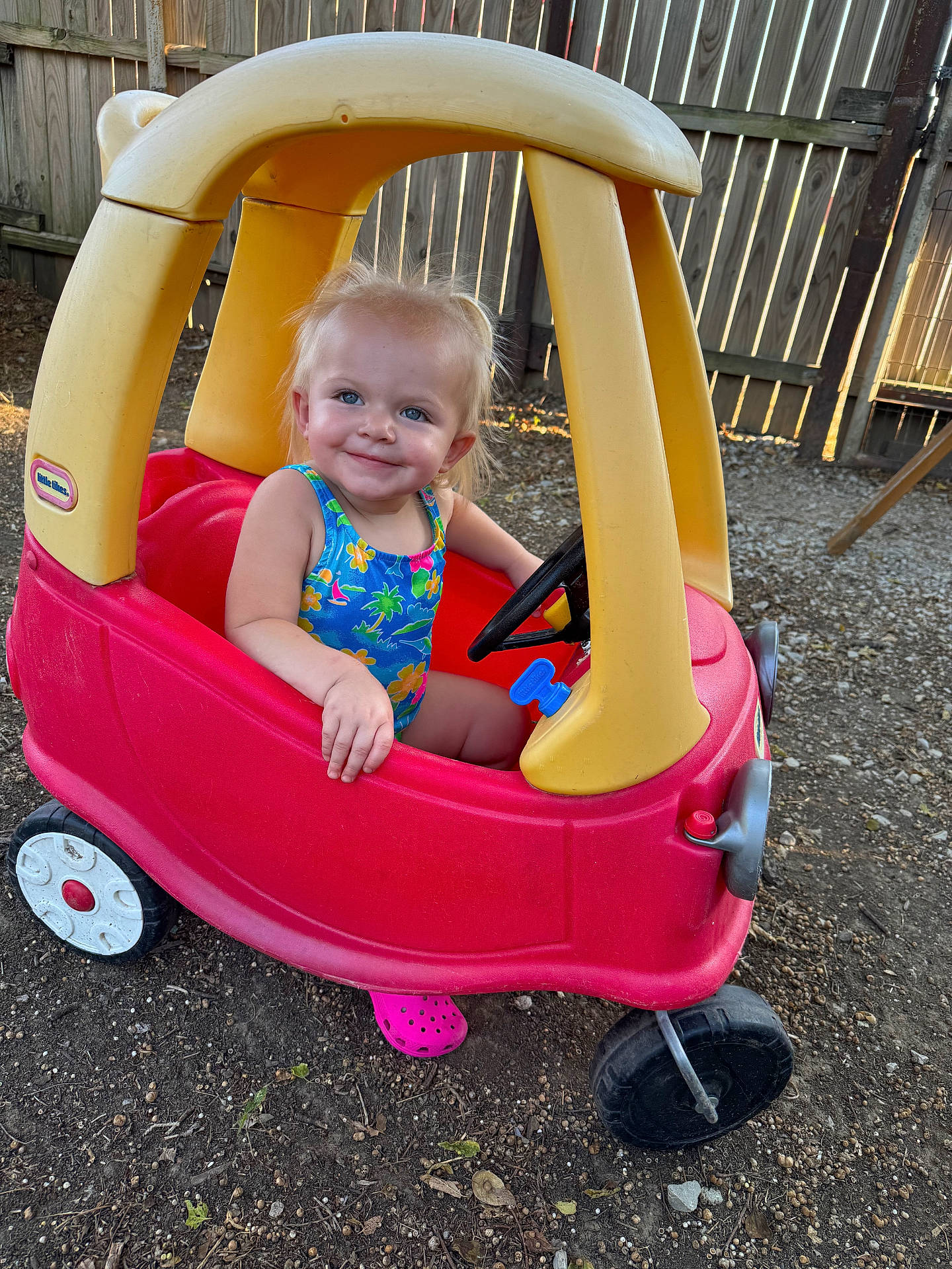 Hollis is registered to the contest to win money with this photo: baby, backyard, face, grass, head, machine, nature, outdoorplayarea, outdoors, person, photography, plant, playarea, portrait, soil, spoke, summer, toy, wheel, yard