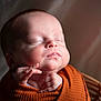 Bryson is registered to the contest to win money with this photo: baby, newborn, sleeping, wrapped, blanket, infant, face, skin, peaceful, portrait, soft_light, cozy, cute, child, closeup, resting, indoors, head, small_hands, warm_colors