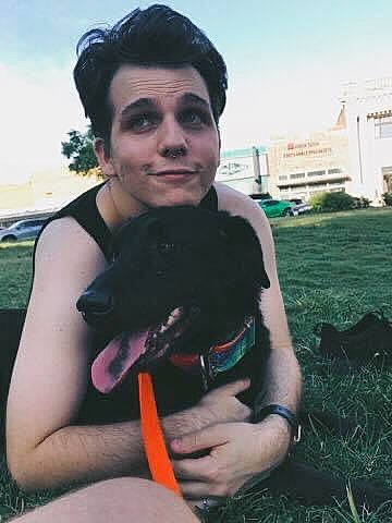 Connor is registered to the contest to win money with this photo: black_hair, canidae, carnivore, companion_dog, dog, dog_breed, eyewear, fawn, fun, fur, gesture, grass, happy, jewellery, plant, sitting, sky, sporting_group, t_shirt, tree