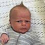 Reggie joined the competition — help win amazing prizes! baby, infant, face, expression, drool, hair, mohawk, clothing, onesie, gray, striped, blanket, crochet, texture, hand, skin, portrait, indoors, cute, person
