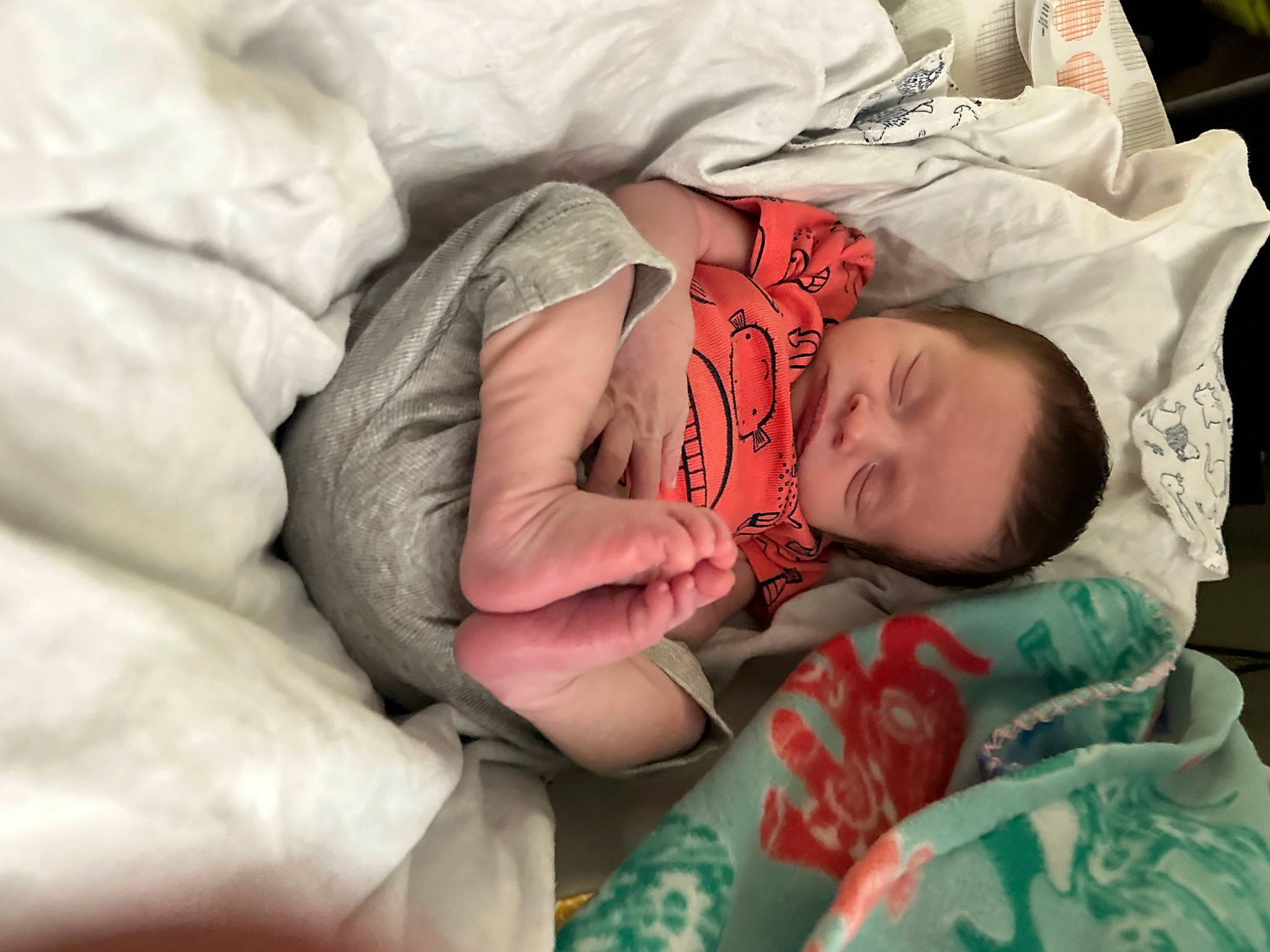 Jaxton is registered to the contest to win money with this photo: baby, baby_products, baby_toddler_clothing, bedtime, carmine, cheek, child, comfort, eye, face, finger, hand, head, linens, nap, person, room, sitting, skin, textile